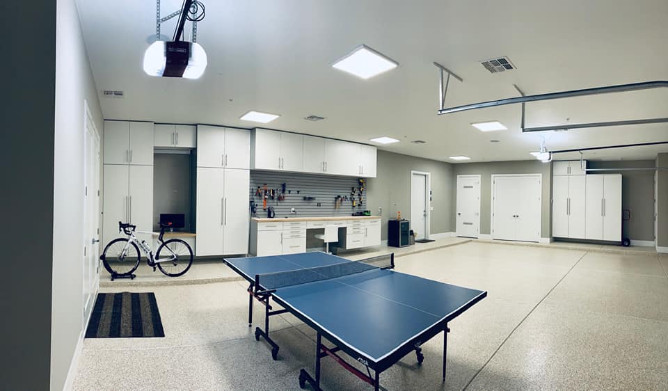 rec room garage with custom cabinets